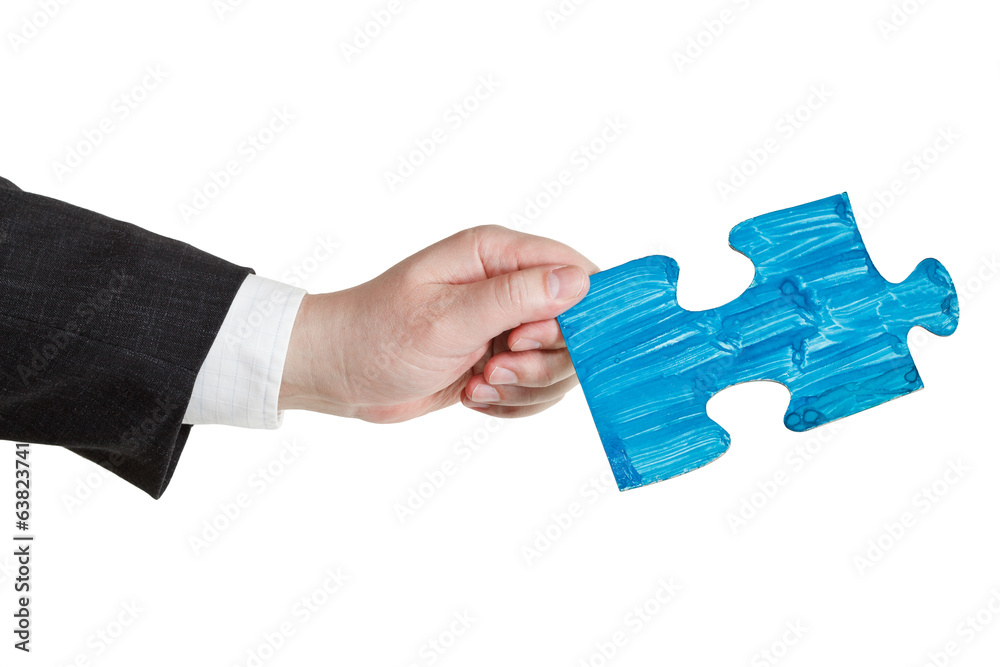 male hand with painted blue puzzle piece male hand with painted blue puzzle piece