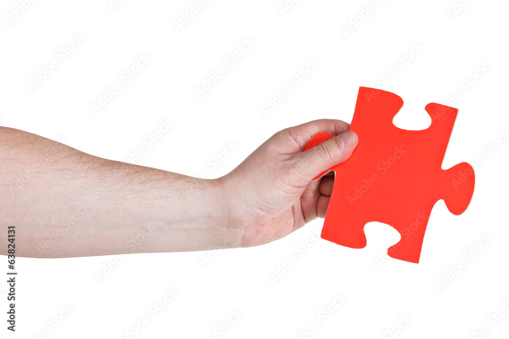 male hand holding big red paper puzzle piece male hand holding big red paper puzzle piece
