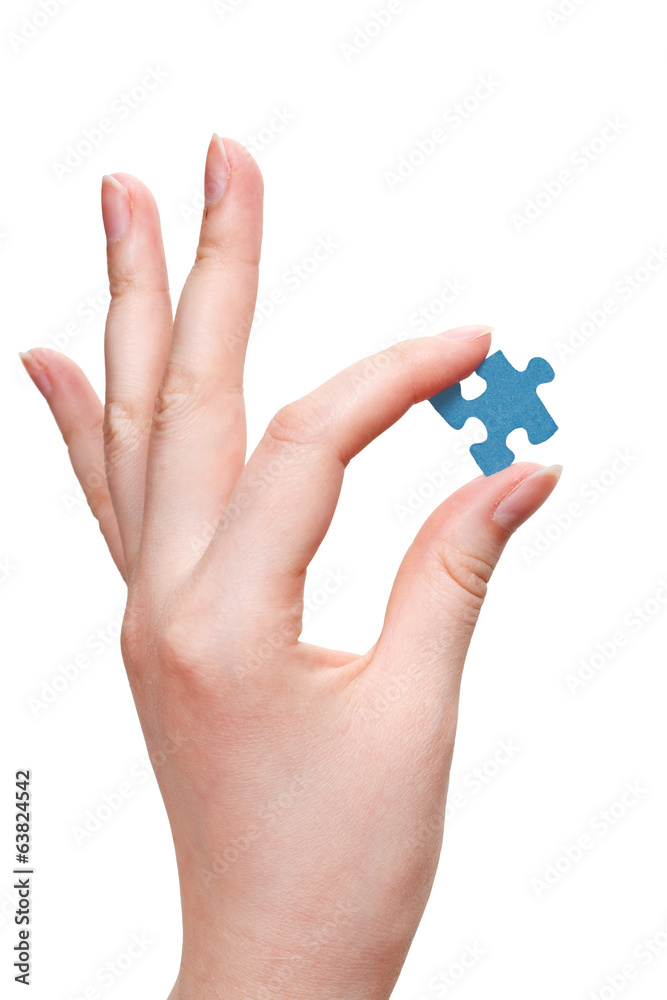 female arm holding puzzle piece