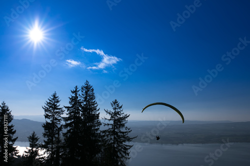 Paraglider over the Zug city, Zugersee and Swiss Alps during a s