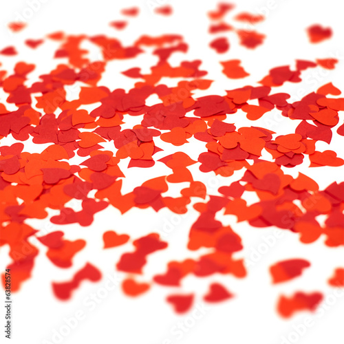 Scattered heart shaped red confetti