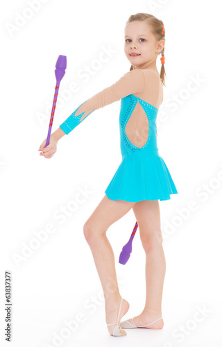 cute girl gymnast with sports maces.