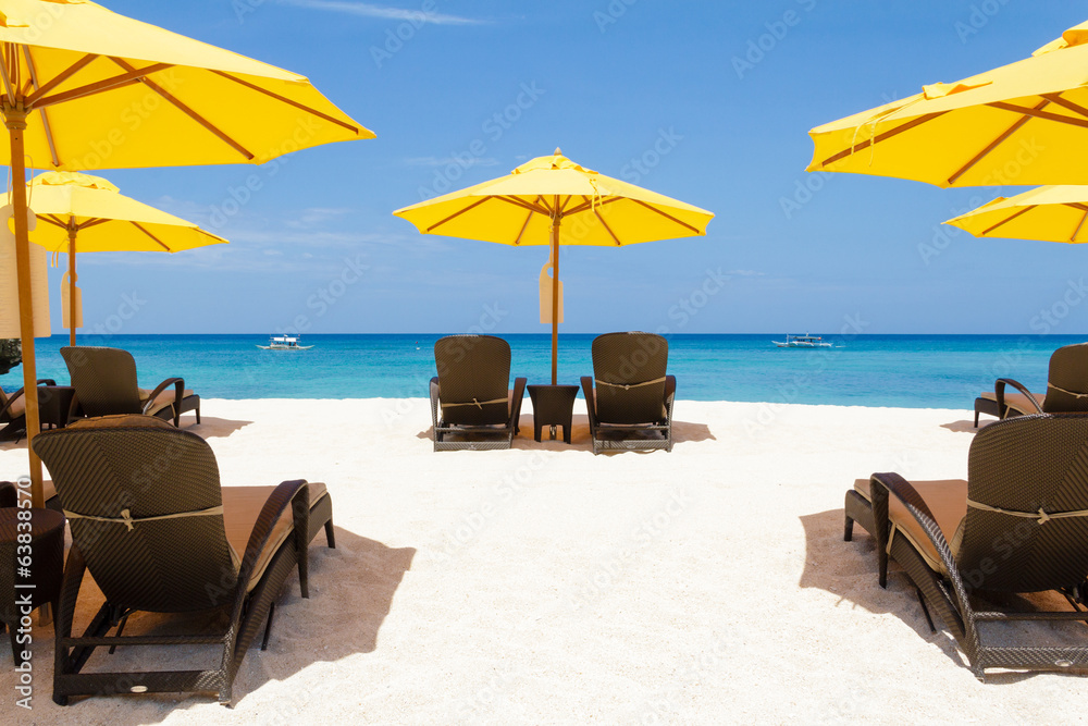 Yellow sun umbrellas and beach chairs