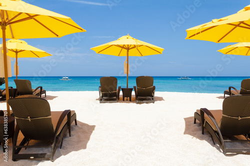 Yellow sun umbrellas and beach chairs