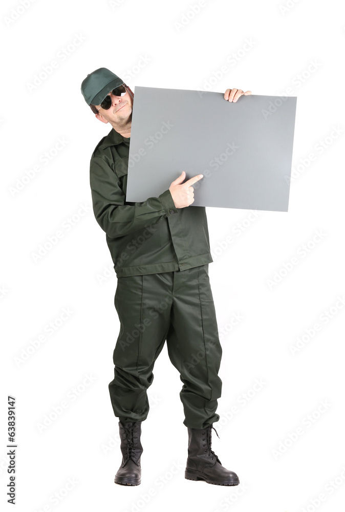 Man in workwear holds paper sheet. Man in workwear holds paper sheet.