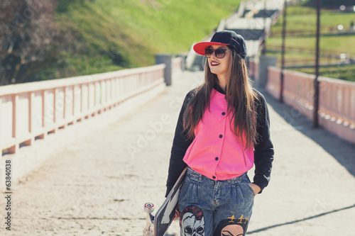 hipster young girl with skate board photo