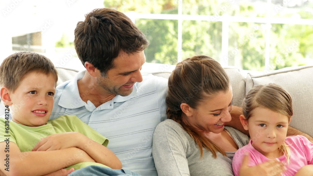Cute family relaxing together on the couch Cute family relaxing together on the couch