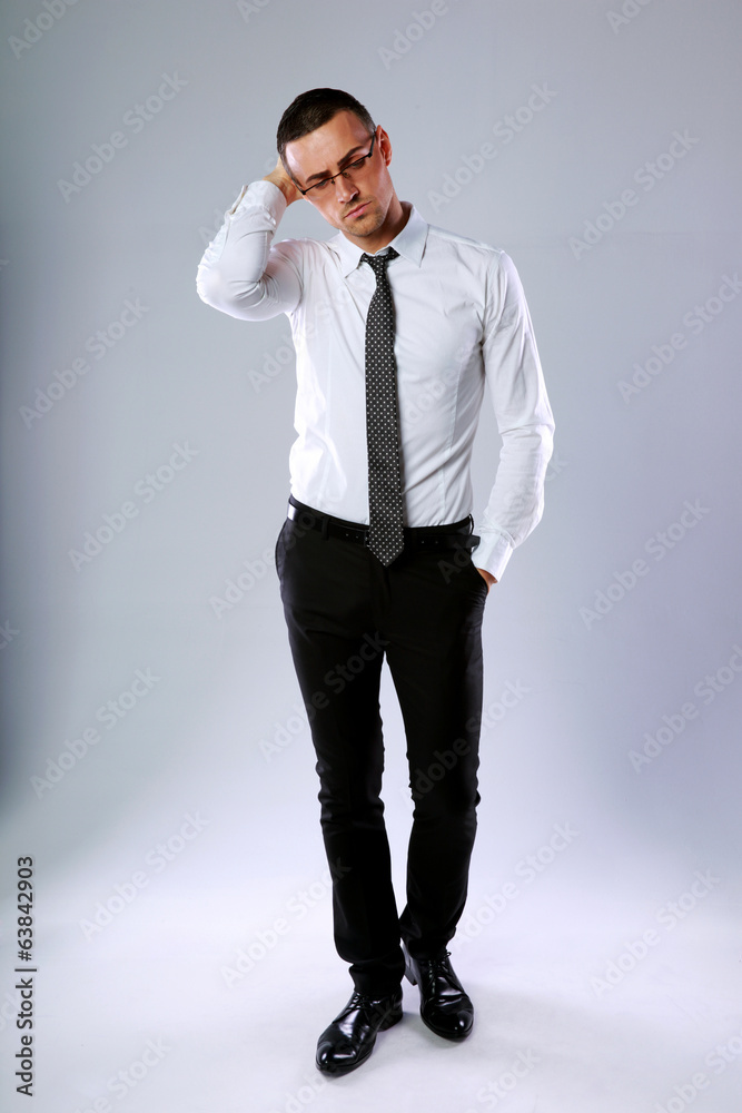 Full-length portrait of confident businessman on gray background Full-length portrait of confident businessman on gray background