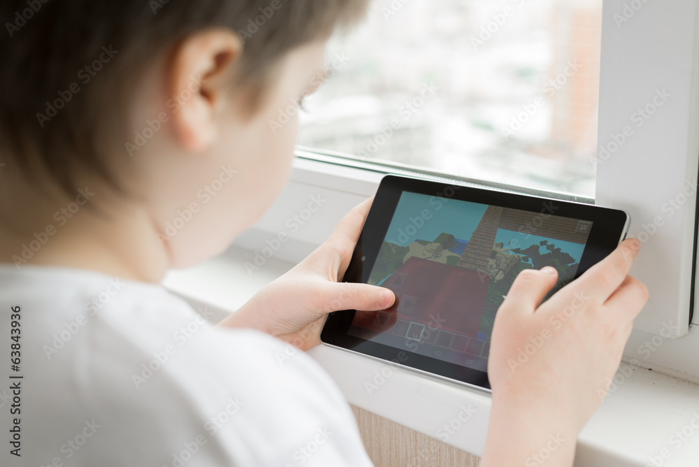 Boy playing on a Tablet PC