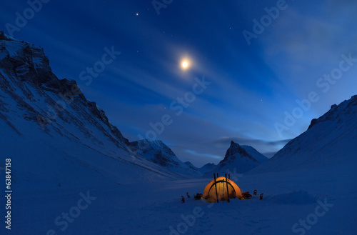 Tent in the mountains on a winter night in Lapland.