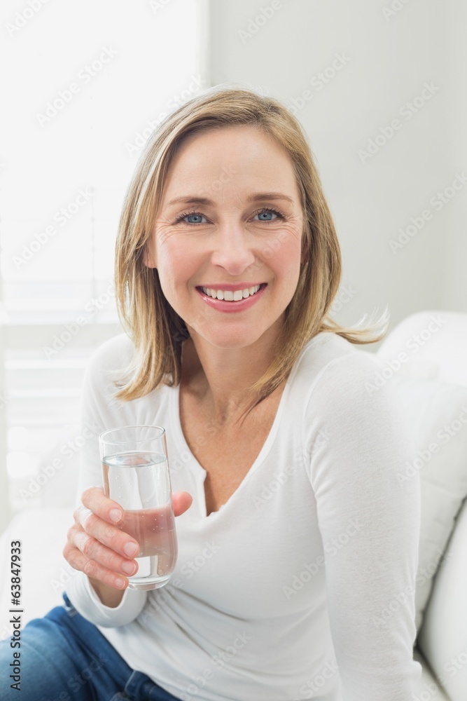 Portrait of a smiling relaxed woman with a glass of water Portrait of a smiling relaxed woman with a glass of water