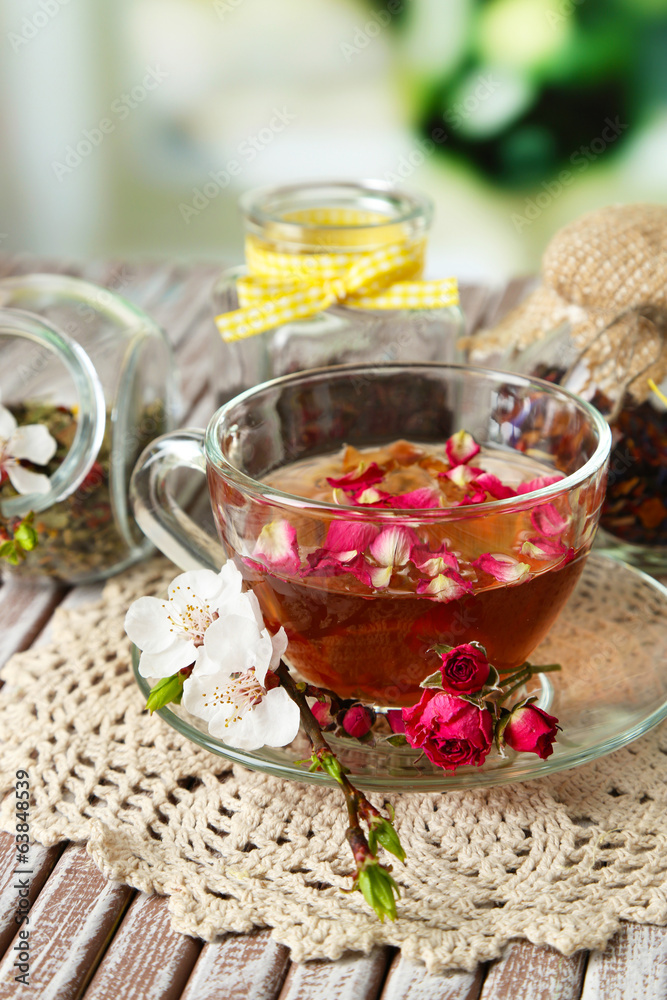 Assortment of herbs, tea in glass jars and hot drink in cup Assortment of herbs, tea in glass jars and hot drink in cup