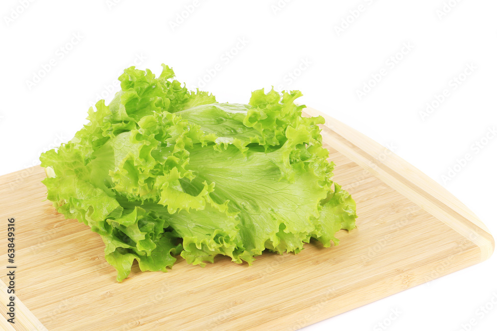 Green salad leaf on cutting board. Green salad leaf on cutting board.