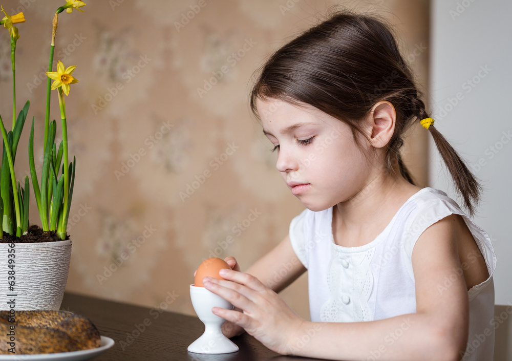 Preschooler girl with Easter egg for breakfast Preschooler girl with Easter egg for breakfast