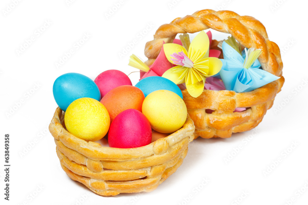 Two baked basket with Easter colored eggs and paper flowers