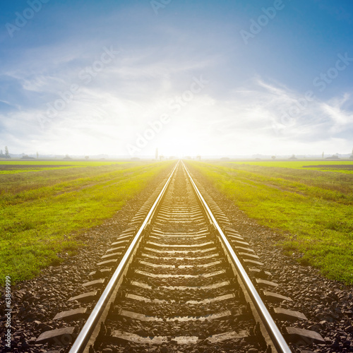 railway leawing far to a sunrise