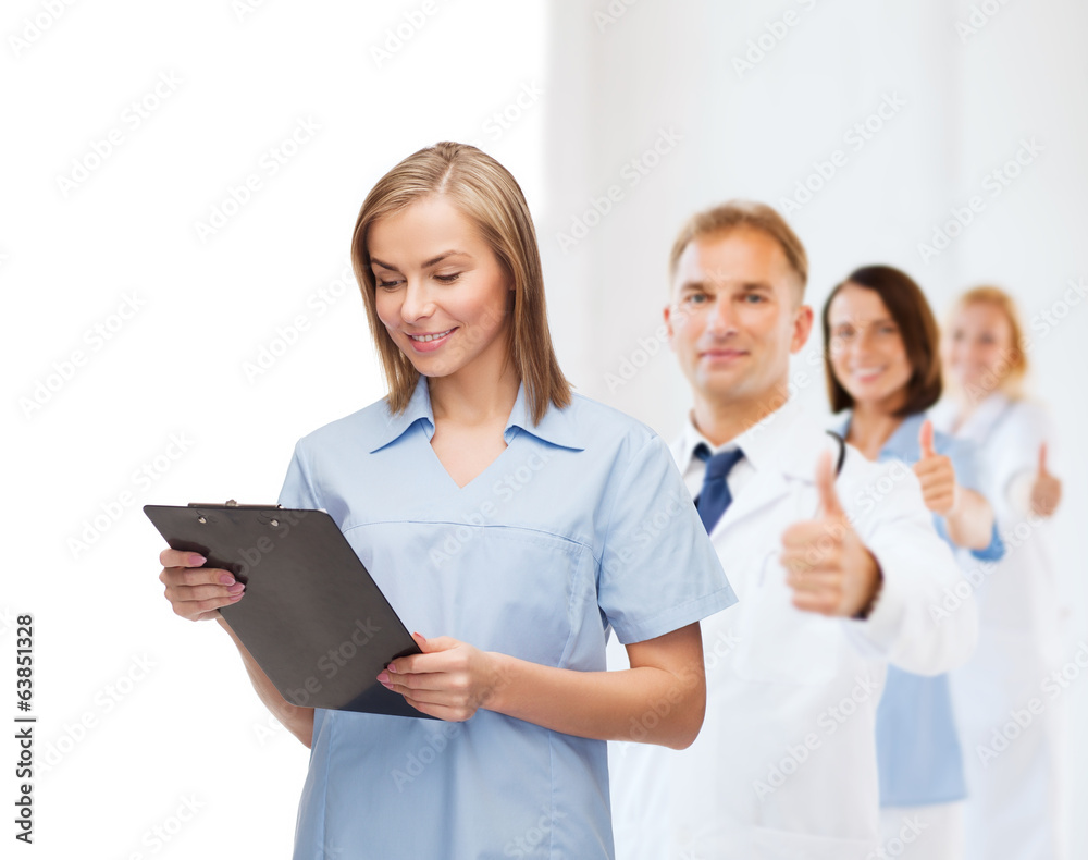 smiling female doctor or nurse with clipboard smiling female doctor or nurse with clipboard