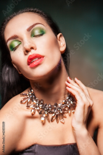 Beautiful woman with Jewelry over dark