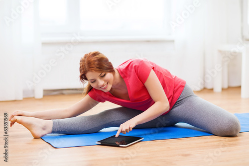 smiling teenage girl streching on floor at home