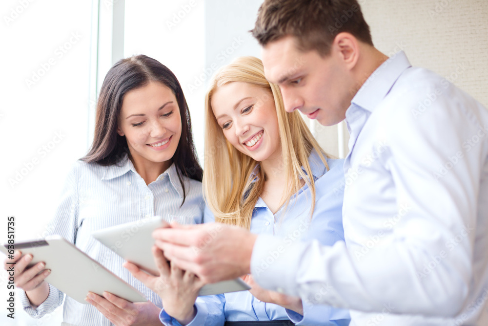 business team working with tablet pcs in office business team working with tablet pcs in office