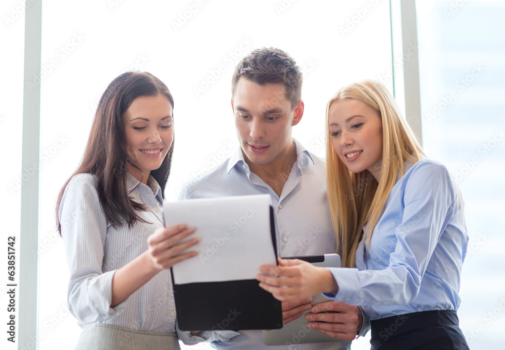 business team looking at clipboard business team looking at clipboard
