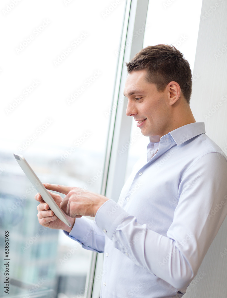 smiling businessman with tablet pc in office smiling businessman with tablet pc in office