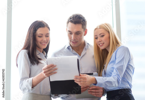 business team looking at clipboard