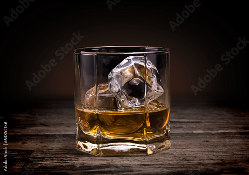 Canvas Print Glasses of whiskey on wood background.