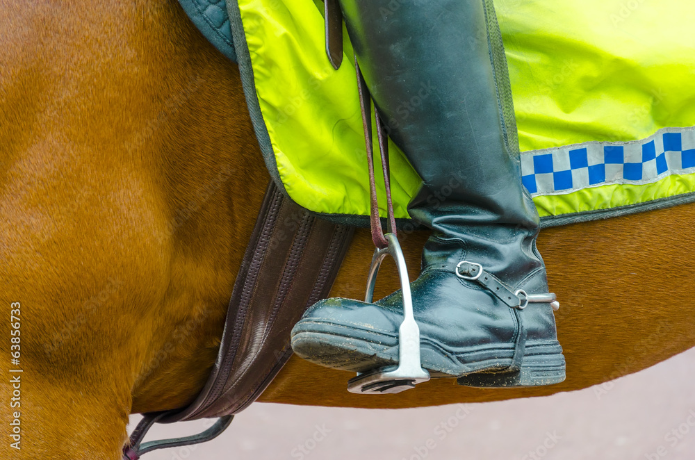 Detail of boots of British policeman on horseback in London Detail of boots of British policeman on horseback in London