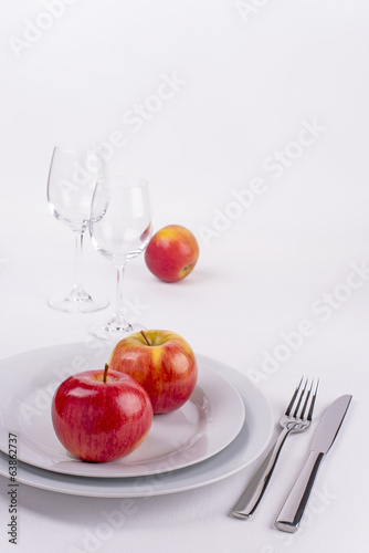 Vertical celebration table set with apples on white