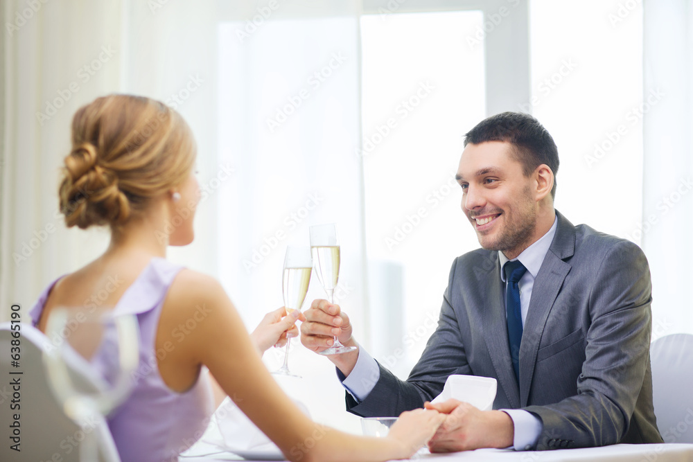 couple with glasses of champagne at restaurant couple with glasses of champagne at restaurant