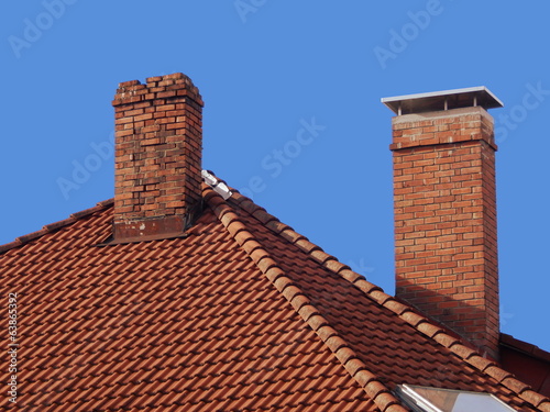 two brick chimneys on the roof, old and new