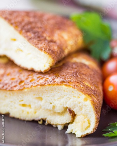 Rolled airy light french omelet with tomato