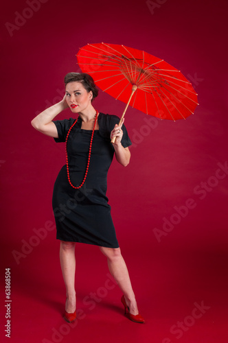 Pinup Girl Poses with Red Umbrella