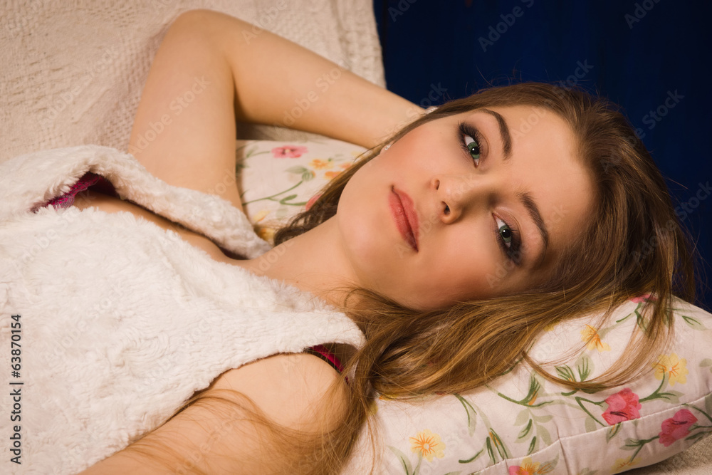 Naklejka premium Attractive girl on a sofa