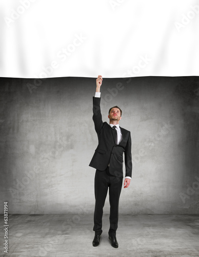 businessman puts a poster