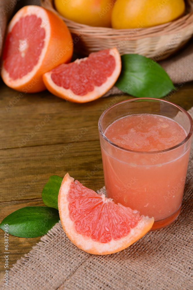 Ripe grapefruit with juice on table close-up Ripe grapefruit with juice on table close-up