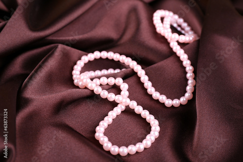 Beautiful pearls on brown silk cloth