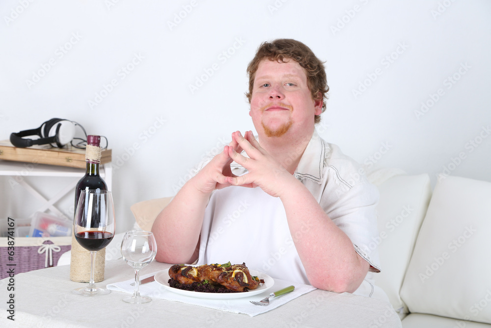 Tasty lunch for fat man, on home interior background Tasty lunch for fat man, on home interior background