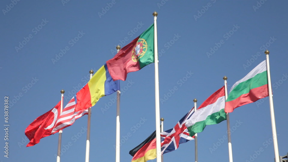 national flags of various countries against a blue sky national flags of various countries against a blue sky