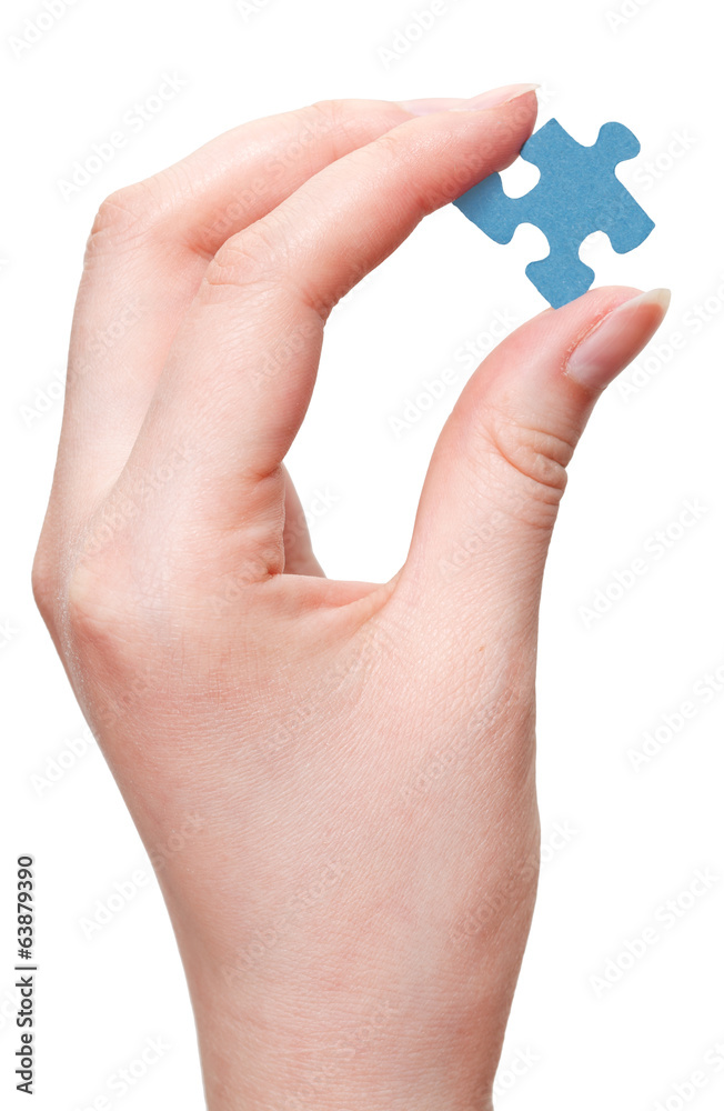 female arm holding blue puzzle piece