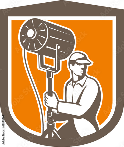 Electrical Lighting Technician With Spotlight Shield
