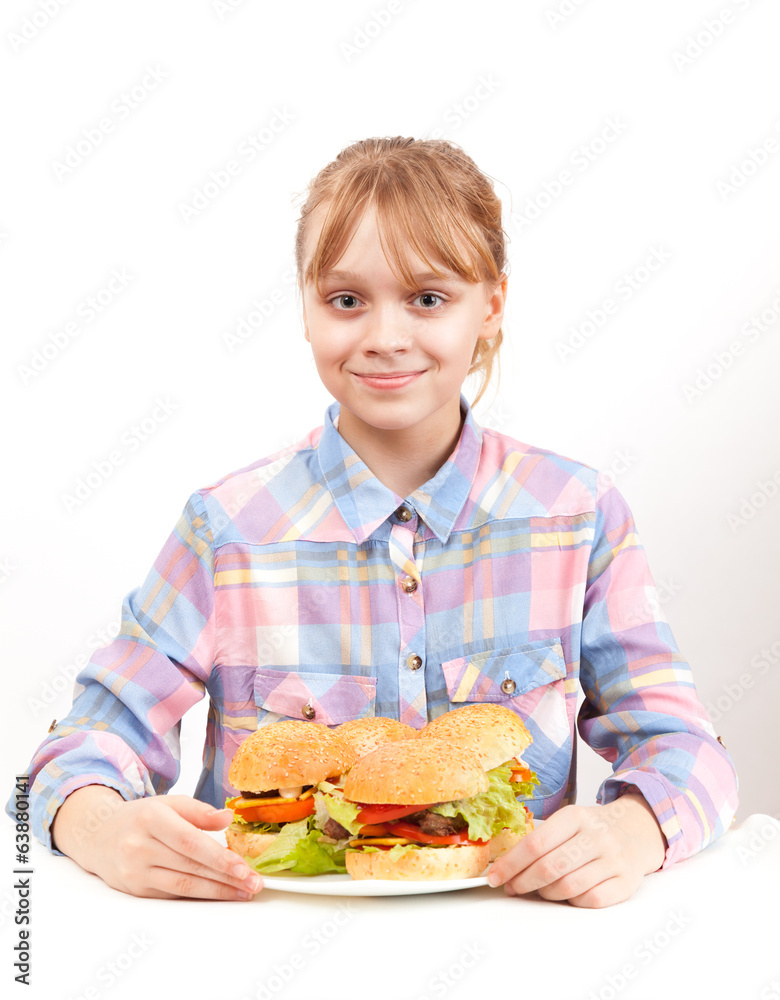 Little smiling blond girl with big homemade hamburgers on white Little smiling blond girl with big homemade hamburgers on white