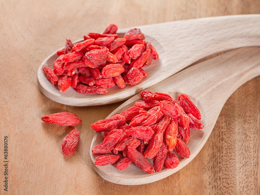 goji berries on wooden background goji berries on wooden background