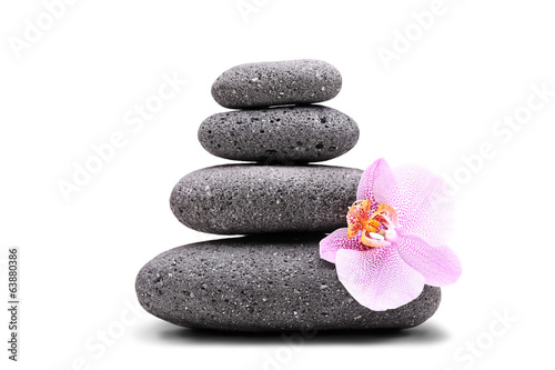 Stack of balanced stones and an orchid