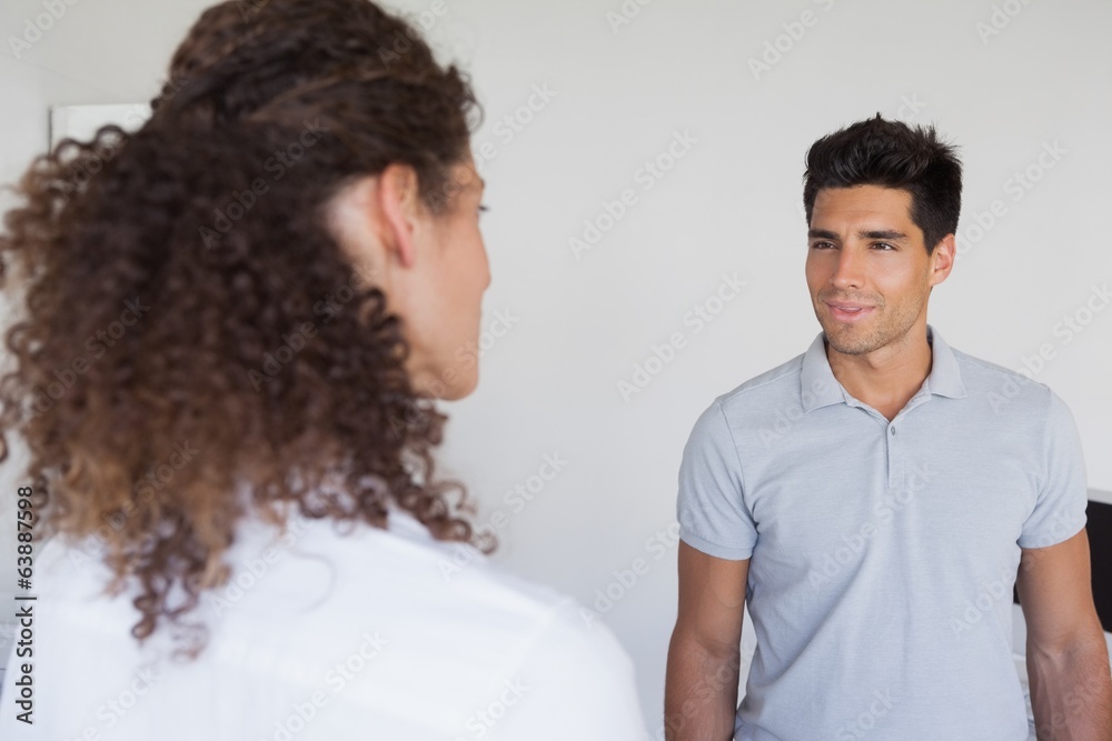 Casual business partners looking at each other Casual business partners looking at each other