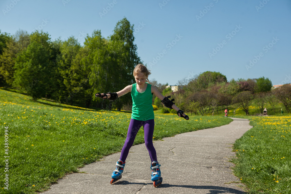 girl on inline skates learns to ride