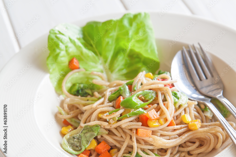 Spaghetti noodles with cream sauce on white plate
