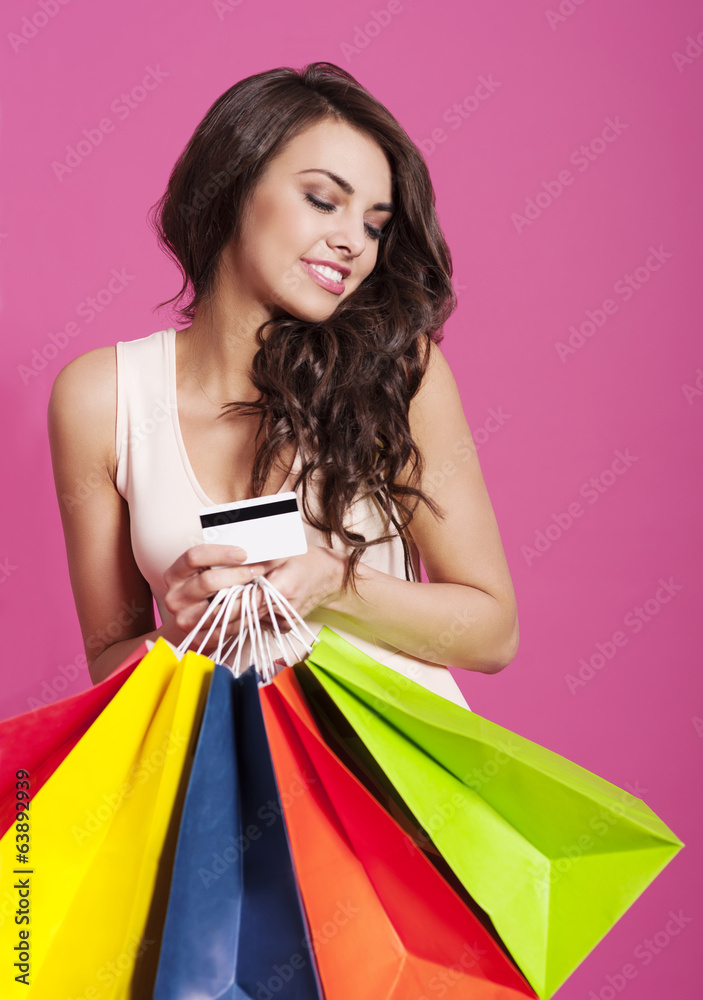 Attractive woman holding shopping bags and credit card Attractive woman holding shopping bags and credit card