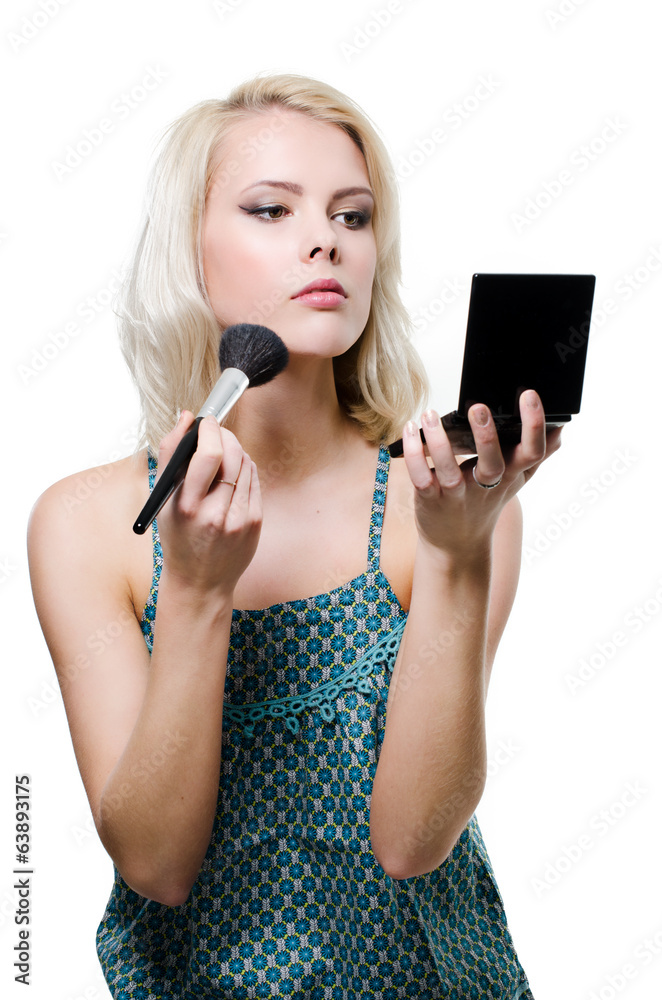 a beautiful young blonde doing makeup